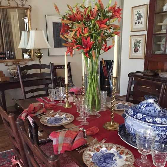 A Lucas/Eilers table setting, complete with collected antique twisted brass candlesticks. If you’re feeling adventurous, blue and red can be a refreshing alternative to the usual tones of orange and gold.